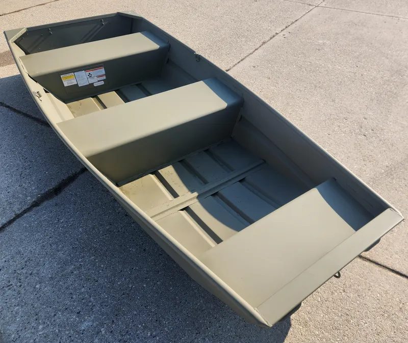 Slide: The Image of 2024 Tracker Grizzly 1236 Jon boat on concrete surface. - 2