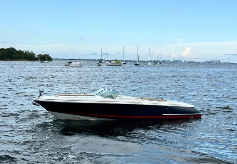 The Image of 2004 Chris-Craft Corsair 28 boat on open water with sailboats in the background. - 0