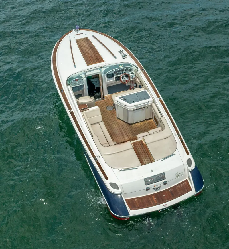 Slide: The Image of 2004 Chris-Craft Corsair 28 boat cruising on open water. - 10
