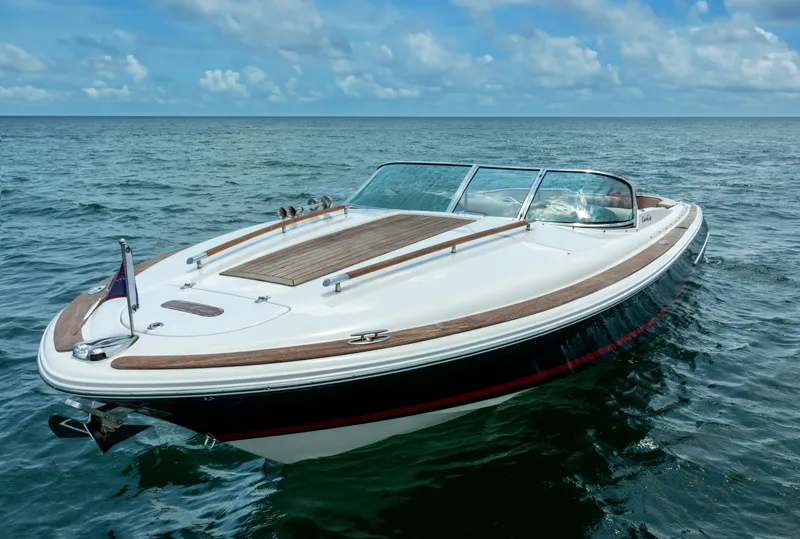 Slide: The Image of 2004 Chris-Craft Corsair 28 boat on open water under a blue sky. - 12