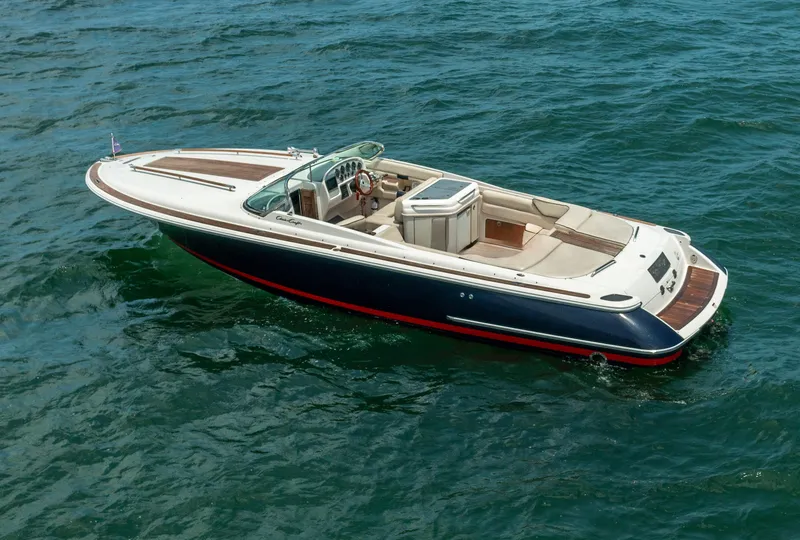 Slide: The Image of 2004 Chris-Craft Corsair 28 boat cruising on open water. - 13