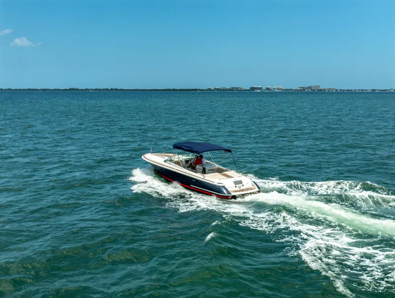 Slide: The Image of 2004 Chris-Craft Corsair 28 boat cruising on open water. - 15
