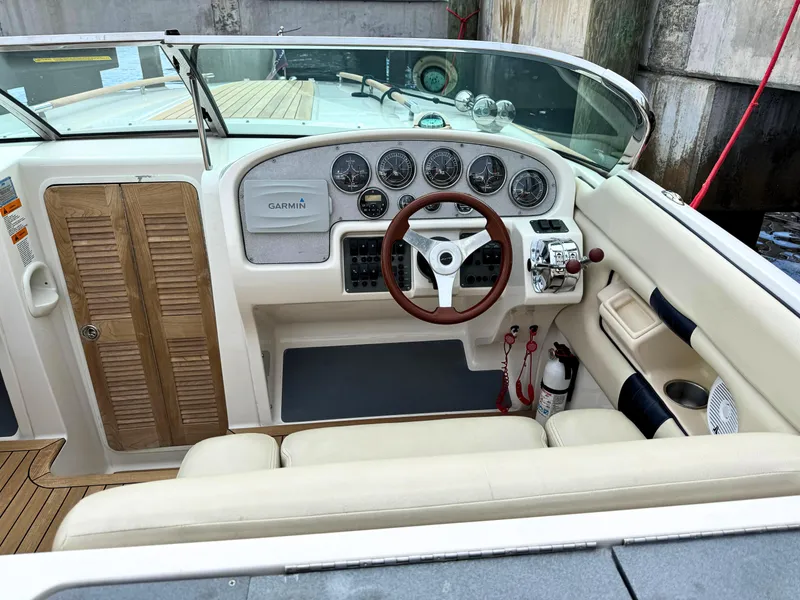 Slide: The Image of 2004 Chris-Craft Corsair 28 boat cockpit with steering wheel and instrument panel. - 17