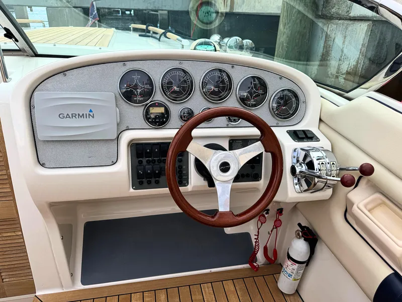 Slide: The Image of 2004 Chris-Craft Corsair 28 helm with Garmin navigation, wooden steering wheel, and control panel. - 18