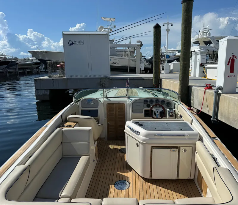Slide: The Image of 2004 Chris-Craft Corsair 28 boat docked at a marina, featuring a spacious interior. - 26
