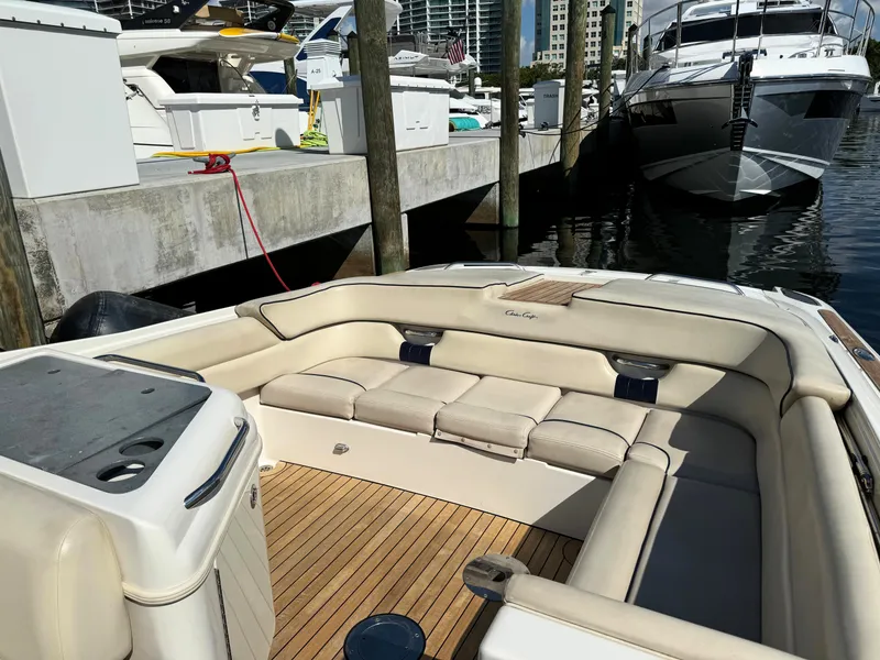 Slide: The Image of 2004 Chris-Craft Corsair 28 boat interior with beige seating at a marina. - 27