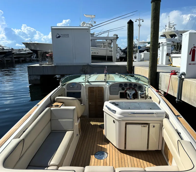 Slide: The Image of 2004 Chris-Craft Corsair 28 boat docked at a marina, featuring a spacious interior. - 29