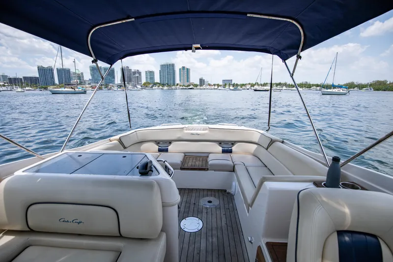 Slide: The Image of 2004 Chris-Craft Corsair 28 boat interior with city skyline and marina in the background. - 30