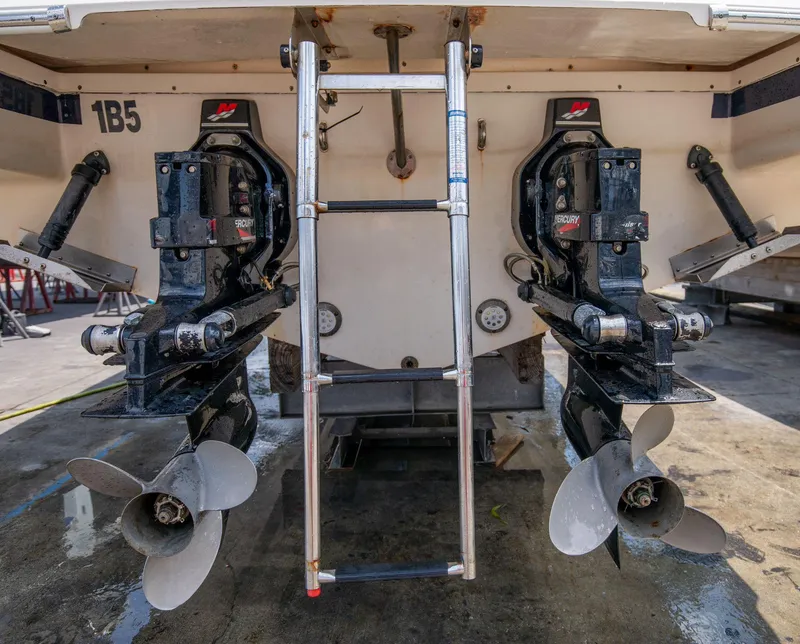 Slide: The Image of 2004 Chris-Craft Corsair 28 boat stern with dual propellers and ladder. - 41