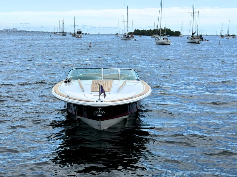 Slide: The Image of 2004 Chris-Craft Corsair 28 boat on open water with other boats in the background. - 6