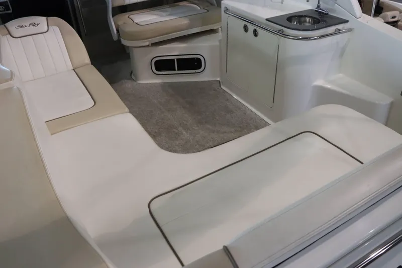 Slide: The Image of 2012 Sea Ray 280 Sundancer interior with seating and kitchenette. - 17