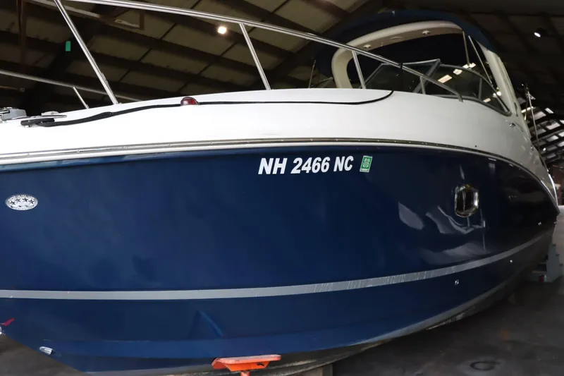 Slide: The Image of 2012 Sea Ray 280 Sundancer boat in storage, blue hull, registration NH 2466 NC. - 4