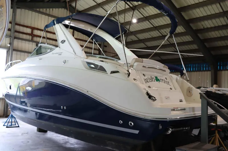 Slide: The Image of 2012 Sea Ray 280 Sundancer boat in a storage facility, named "Irish Mist." - 5