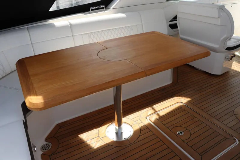 Slide: The Image of Interior of 2020 Sea Ray 400SLX with wooden table and white seating. - 10