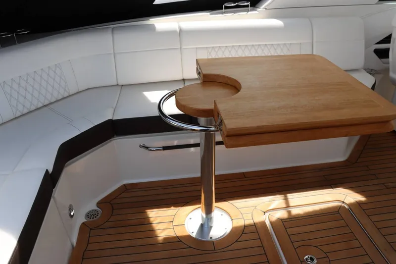 Slide: The Image of Interior seating and table of 2020 Sea Ray 400SLX boat with wooden flooring. - 11