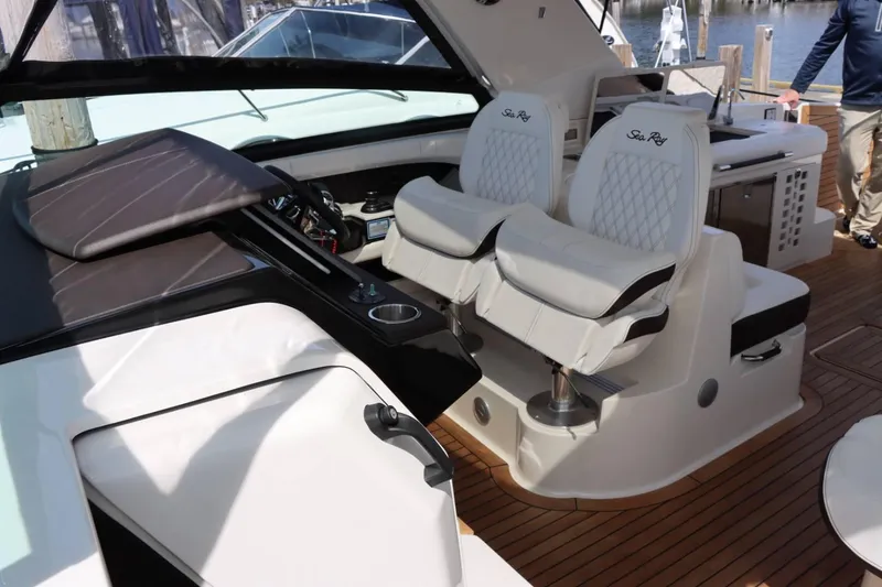 Slide: The Image of Interior of 2020 Sea Ray 400SLX boat with luxurious seating and modern dashboard. - 13