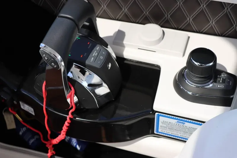 Slide: The Image of Sea Ray 400SLX 2020 boat control panel with throttle and joystick. - 14