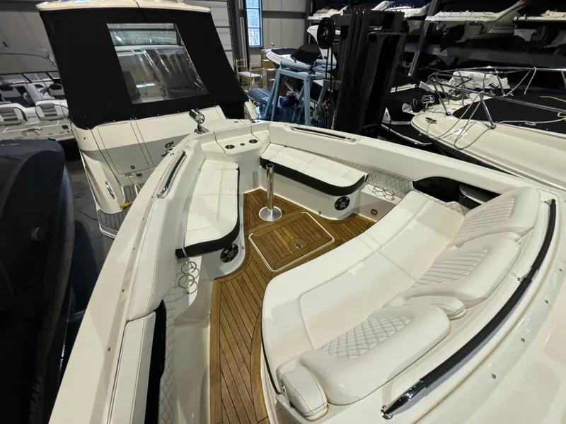 Slide: The Image of 2020 Sea Ray 400SLX boat interior with white seating and wooden flooring. - 26