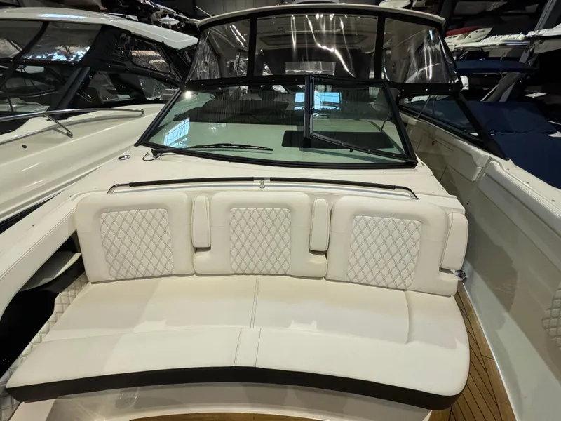 Slide: The Image of 2020 Sea Ray 400SLX boat interior with white cushioned seating and windshield. - 27