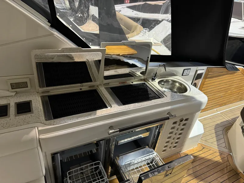 Slide: The Image of Sea Ray 400SLX 2020 boat kitchen area with grill, sink, and storage. - 28