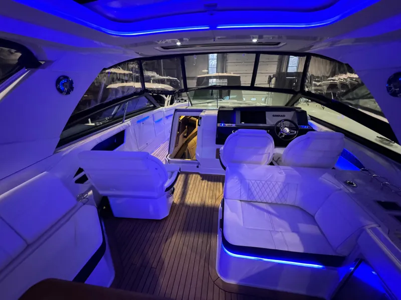 Slide: The Image of Interior of a 2020 Sea Ray 400SLX boat with blue LED lighting. - 30