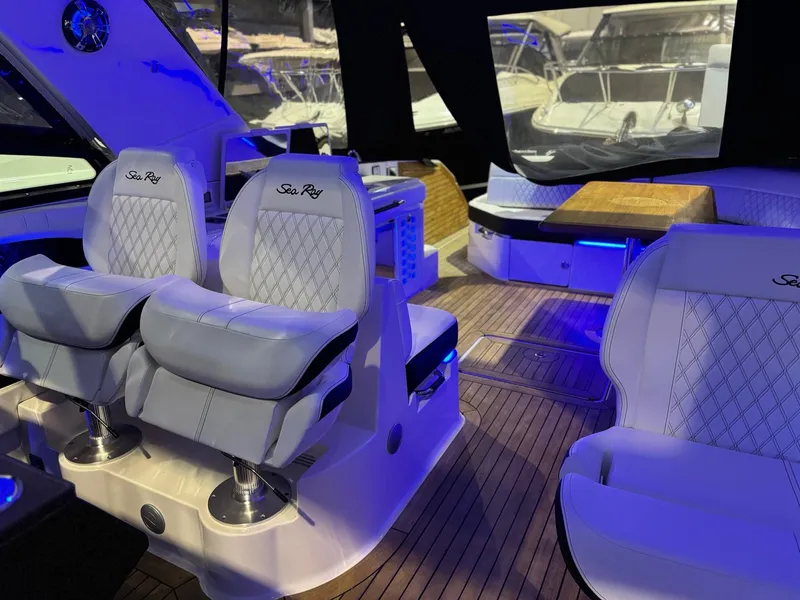 Slide: The Image of Interior of a 2020 Sea Ray 400SLX boat with luxurious seating and wood flooring. - 31