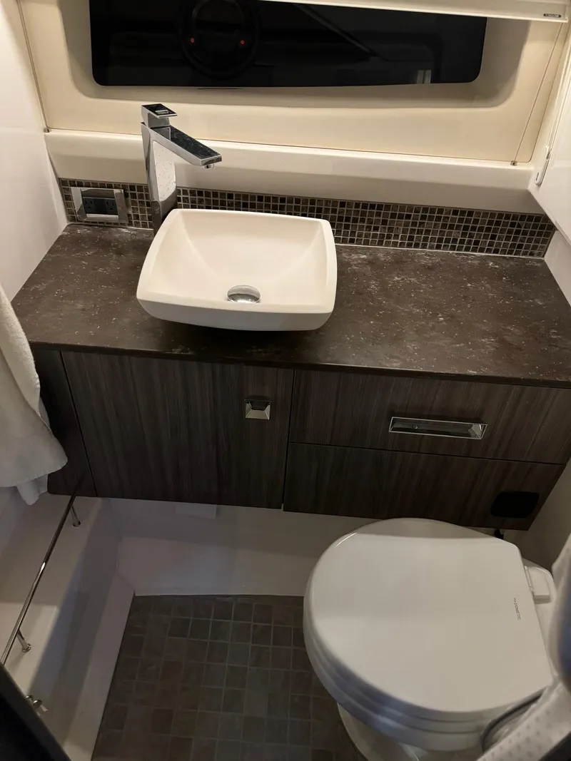 Slide: The Image of Modern bathroom in 2020 Sea Ray 400SLX boat with sink and toilet. - 32