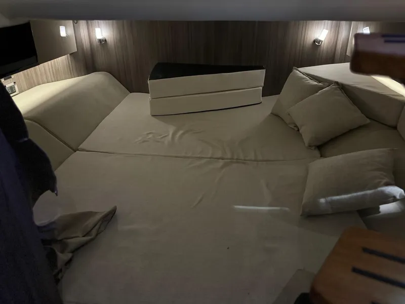 Slide: The Image of Interior cabin of 2020 Sea Ray 400SLX with beige cushions and ambient lighting. - 33