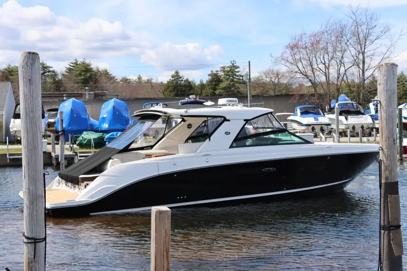 Slide: The Image of 2020 Sea Ray 400SLX luxury boat docked at a marina. - 5