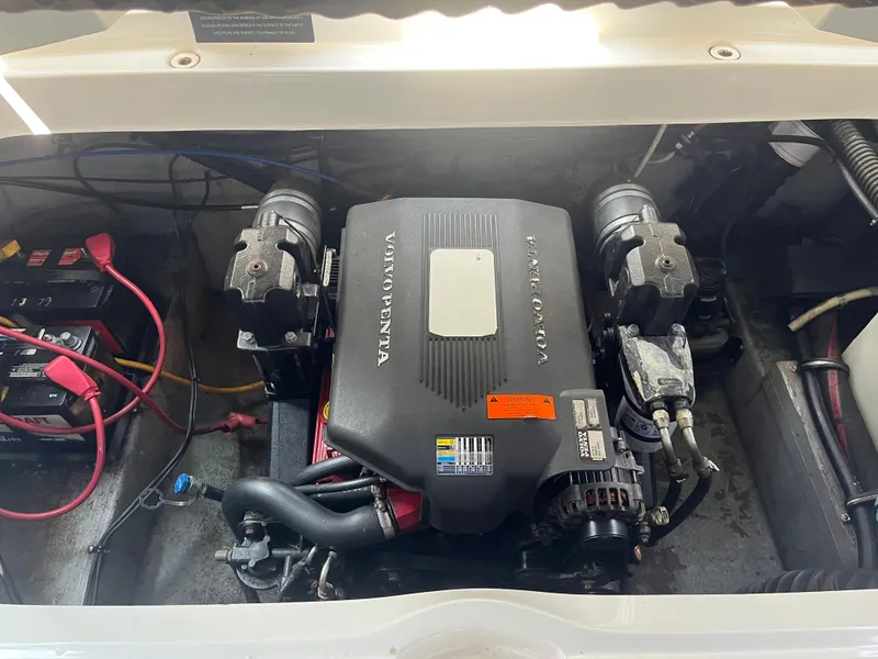 Slide: The Image of 2004 Crownline 270BR engine compartment with Volvo Penta engine and battery. - 10