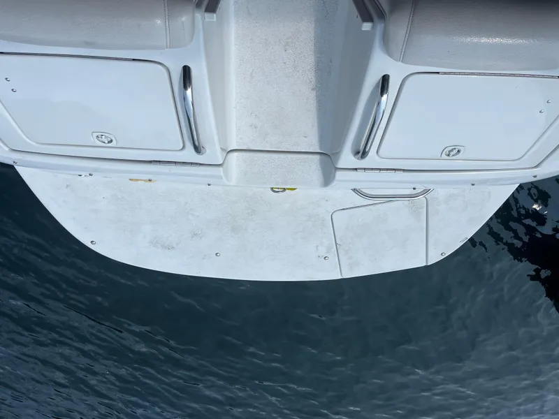 Slide: The Image of 2004 Crownline 270BR boat stern with swim platform on water. - 3