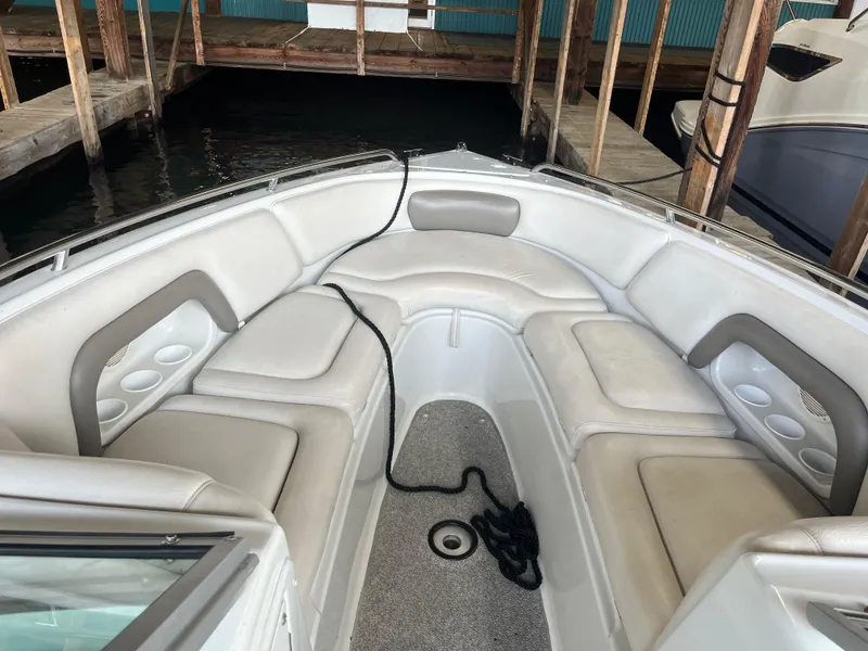 Slide: The Image of 2004 Crownline 270BR boat interior with cushioned seating and cup holders. - 6