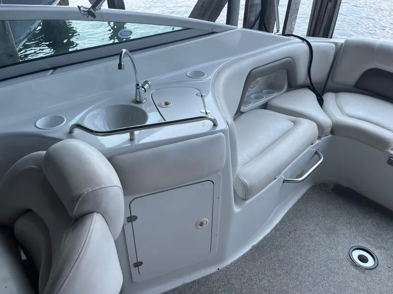 Slide: The Image of 2004 Crownline 270BR boat interior with sink and seating area. - 7
