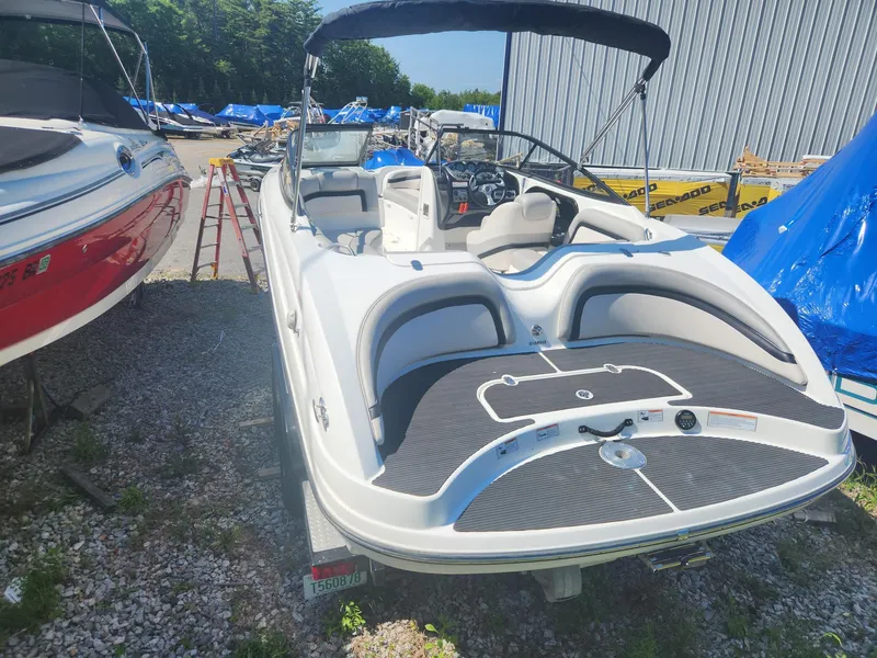 Slide: The Image of 2010 Yamaha Boats 212SS in a boatyard, rear view with seating and controls visible. - 3