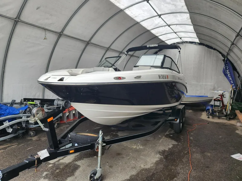 Slide: The Image of 2010 Yamaha Boats 212SS in storage on a trailer. - 8
