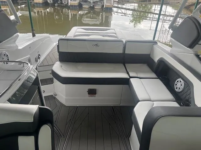 Slide: The Image of 2022 Monterey 298 Super Sport boat interior with white and black seating. - 12