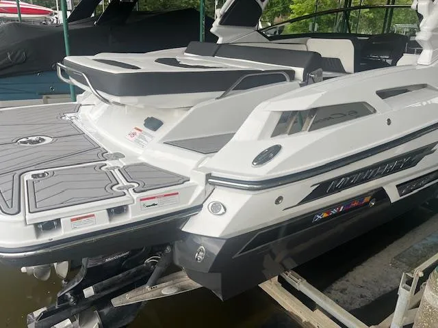 Slide: The Image of 2022 Monterey 298 Super Sport boat docked, rear view showing swim platform and seating. - 4
