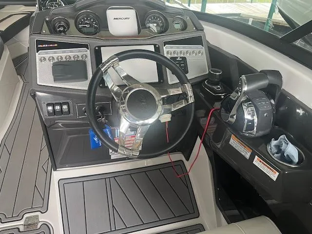 Slide: The Image of 2022 Monterey 298 Super Sport boat dashboard with steering wheel and control panel. - 7