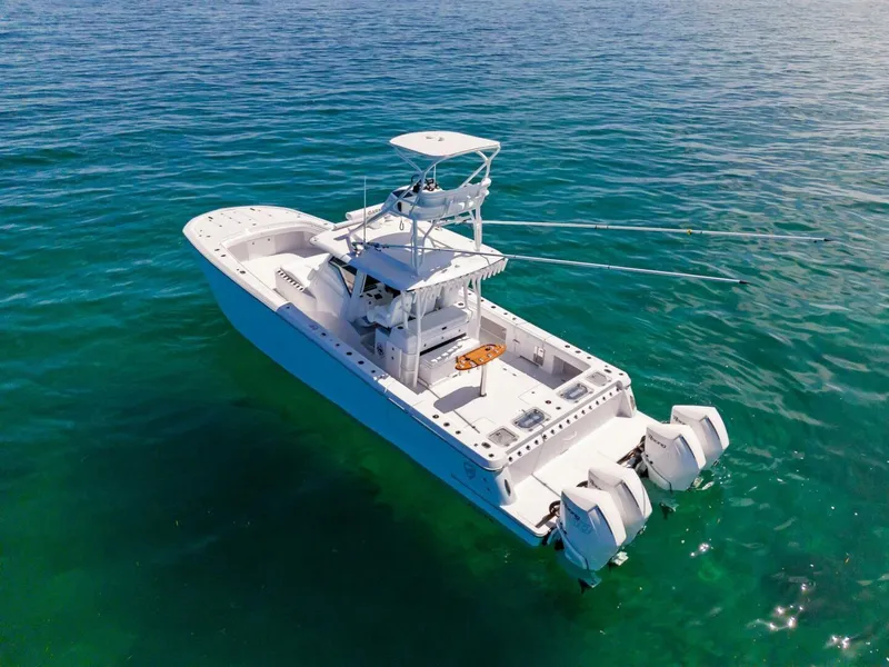 Slide: The Image of 2023 Barker Boatworks 40 HPC on clear blue water. - 33