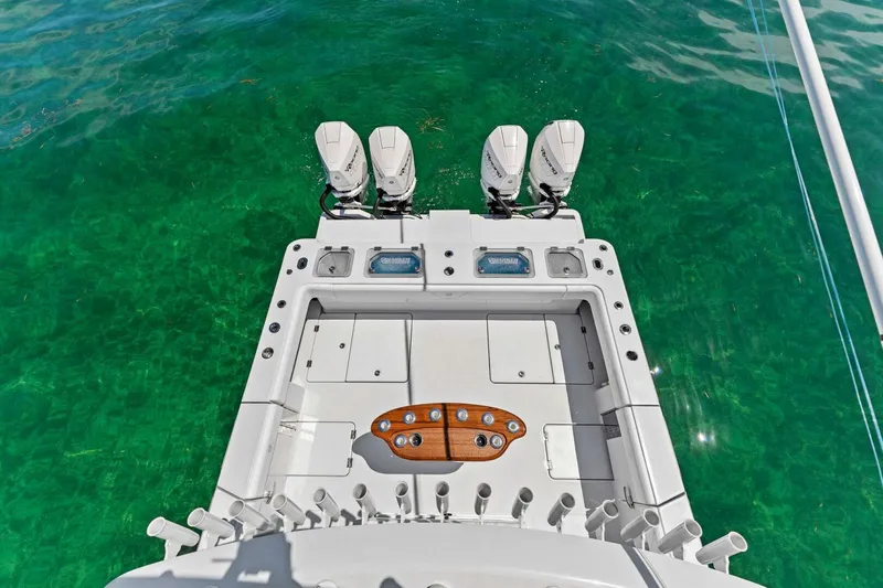 Slide: The Image of 2023 Barker Boatworks 40 HPC with triple outboard engines on clear water. - 6