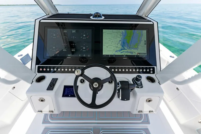 Slide: The Image of 2023 Barker Boatworks 40 HPC helm with dual displays and steering wheel. - 7