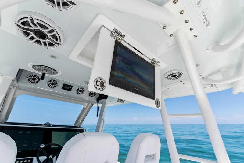 Slide: The Image of 2023 Barker Boatworks 40 HPC helm with advanced electronics and ocean view. - 9