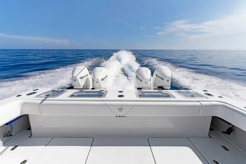 Slide: The Image of 2023 Barker Boatworks 40 HPC cruising on open water with triple outboard engines. - 23