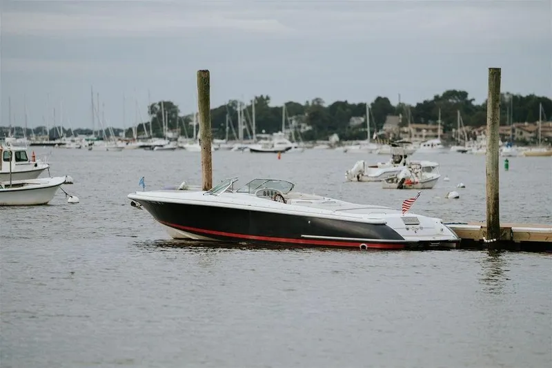 Slide: The Image of 2004 Chris-Craft 28 LAUNCH boat docked in a marina with other boats in the background. - 0