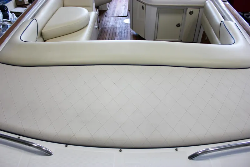 Slide: The Image of 2004 Chris-Craft 28 Launch boat interior with cream leather seating and wood flooring. - 13