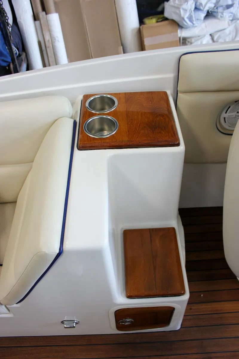Slide: The Image of 2004 Chris-Craft 28 Launch boat interior with wooden cup holders and seating. - 20