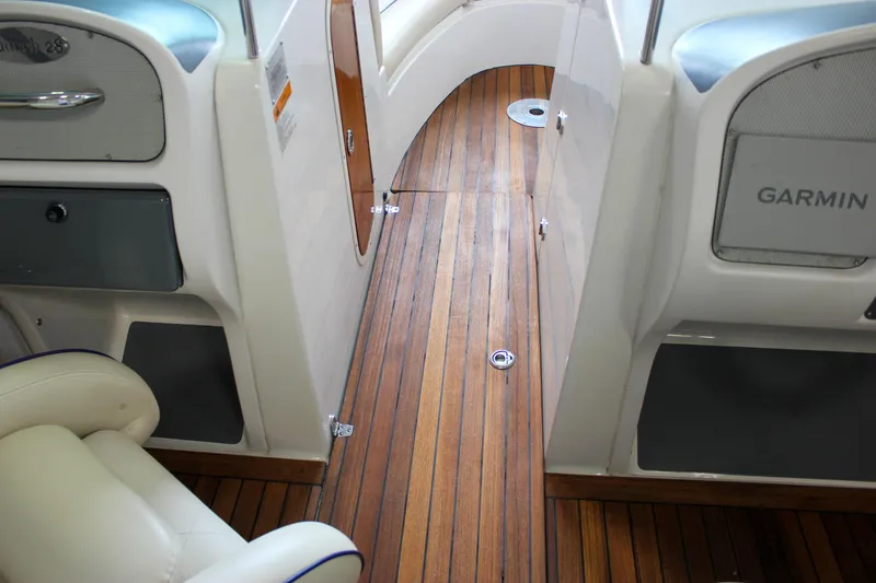 Slide: The Image of 2004 Chris-Craft 28 LAUNCH interior with wooden flooring and Garmin equipment. - 22