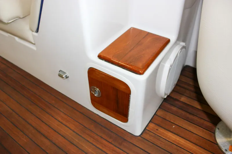 Slide: The Image of 2004 Chris-Craft 28 Launch interior detail with wooden step and storage compartment. - 24