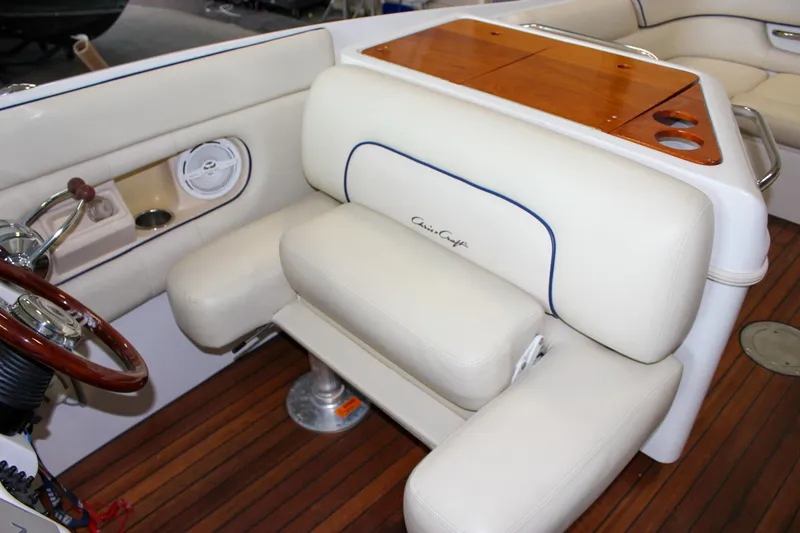 Slide: The Image of 2004 Chris-Craft 28 Launch boat interior with white seating and wooden accents. - 25