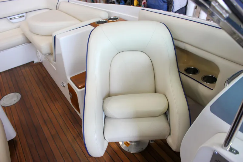 Slide: The Image of 2004 Chris-Craft 28 LAUNCH boat interior with white seating and wooden flooring. - 27
